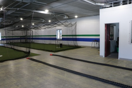 Two batting cages, fitness rope, and fitness equipment storage