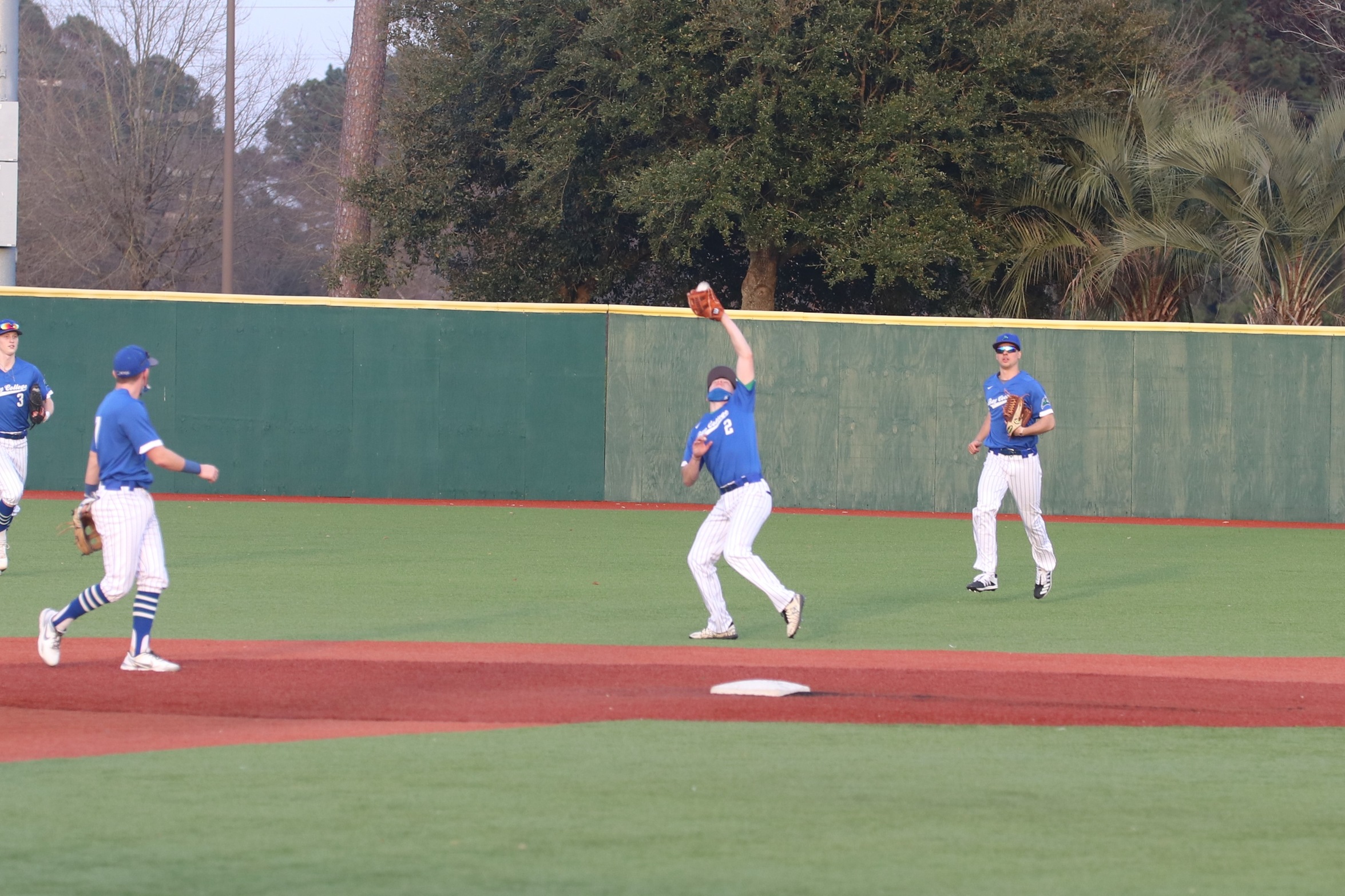 Carson Shea catches a pop fly as his teammates look on