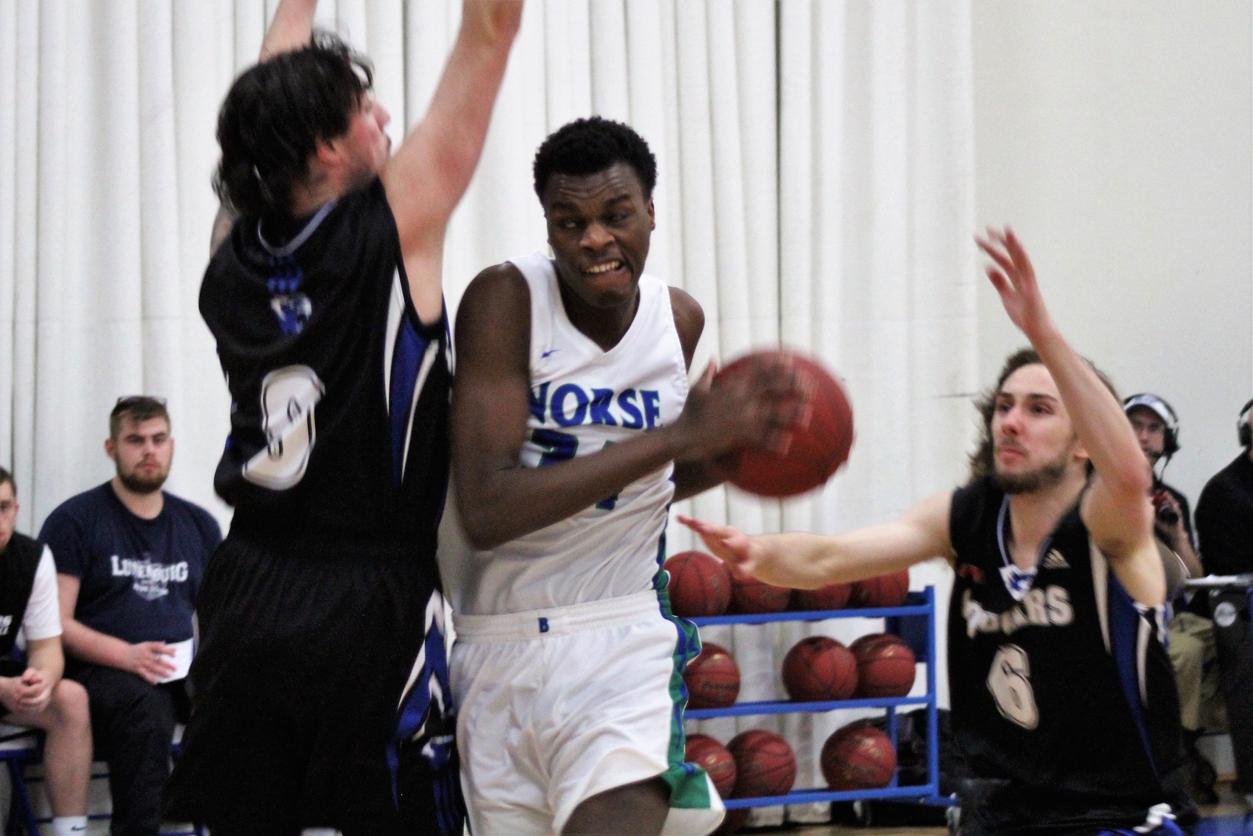 Kobi Barnes tries to get to the basket with a defender in his way