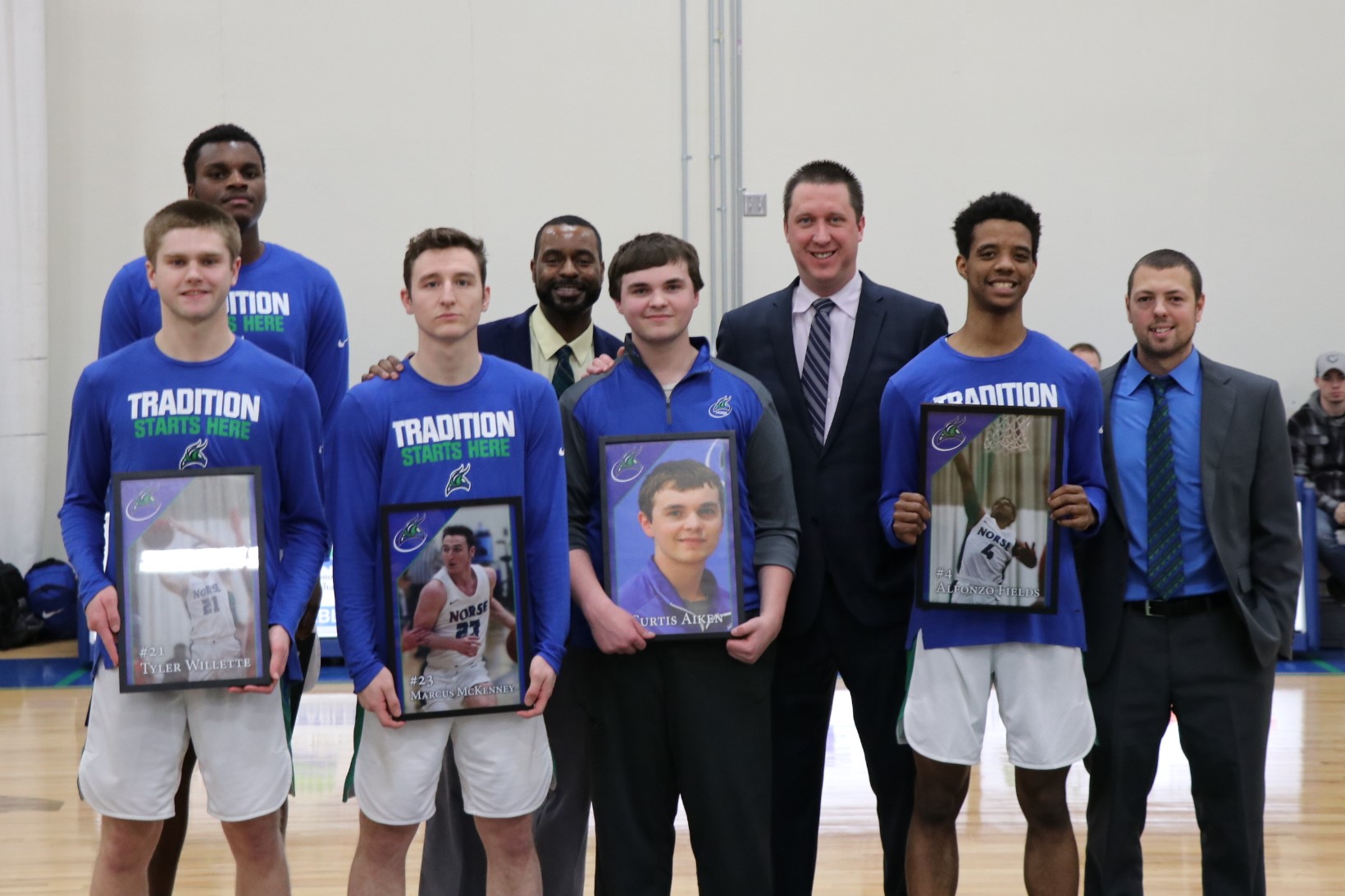 Front row, left to right: Tyler Willette, Marcus McKenney, Curtis Aiken, and Alfonzo Fields all holding pictures they were just given.  Back row, left to right: Kobi Barnes, Narveil Fernandez, Matt Johnson, Matt Gregory
