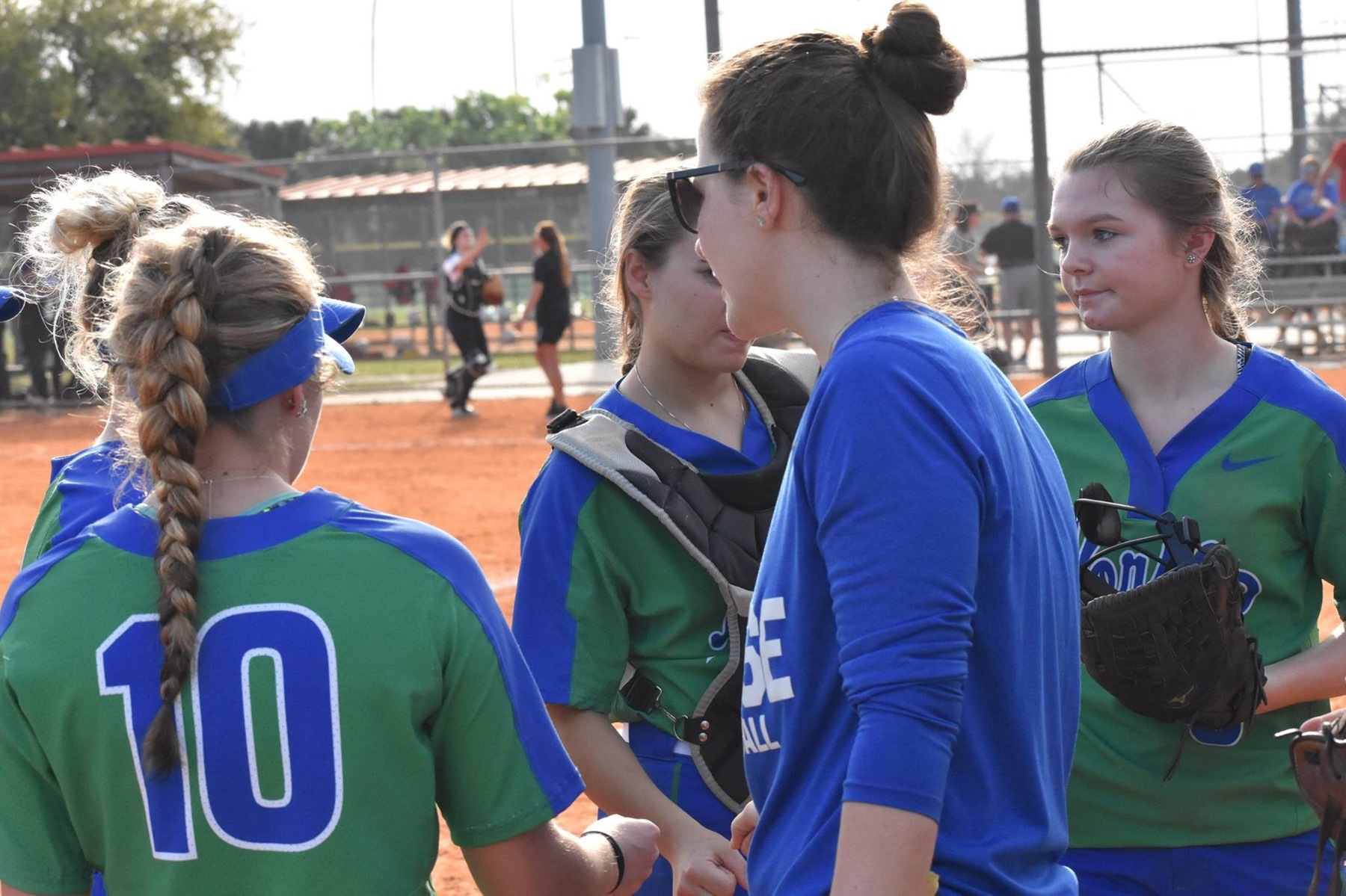 Heidi Charon talks with several players in between innings