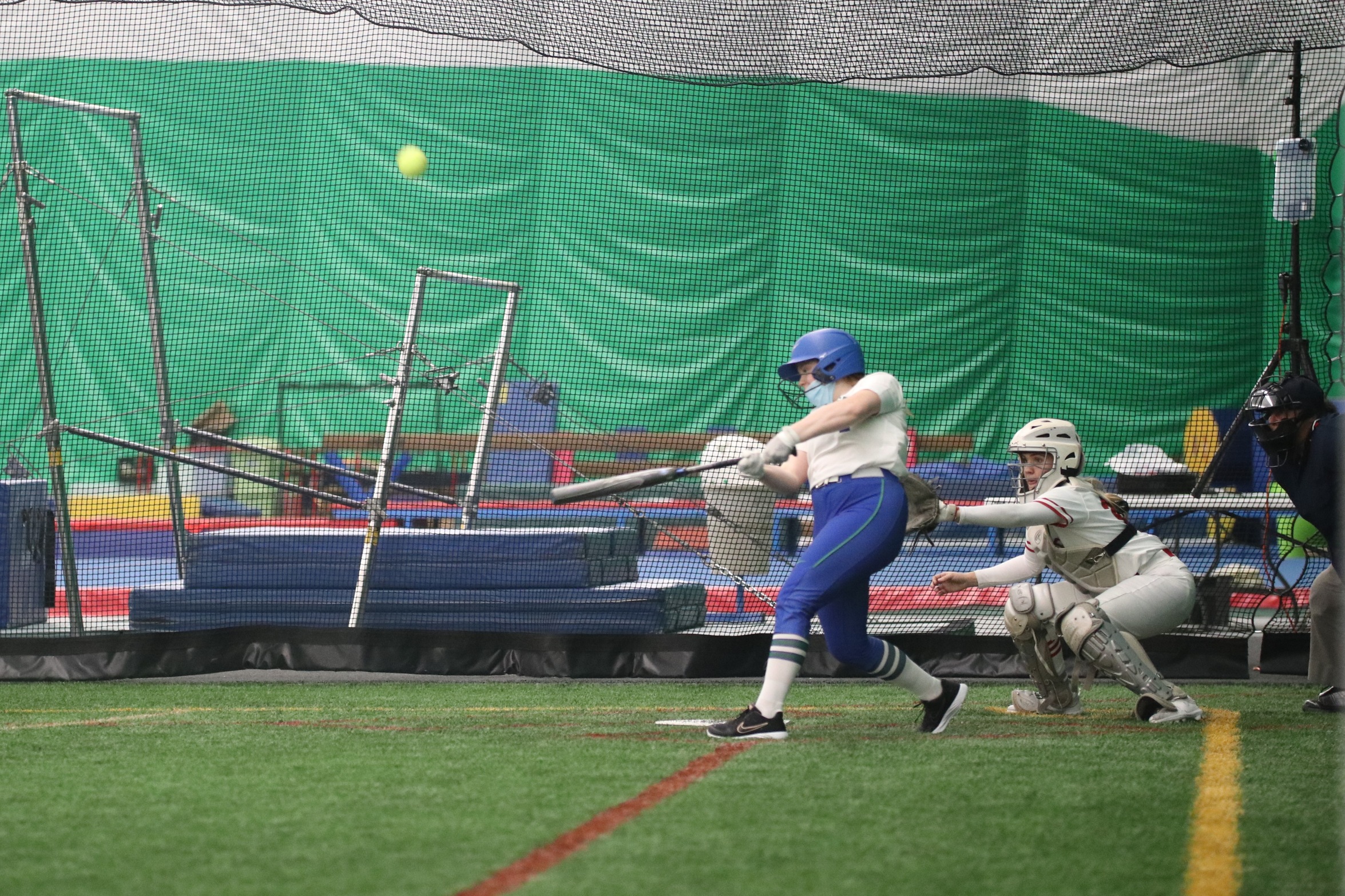 Kristin Goodacre at the plate, having just hit a ball in the air.