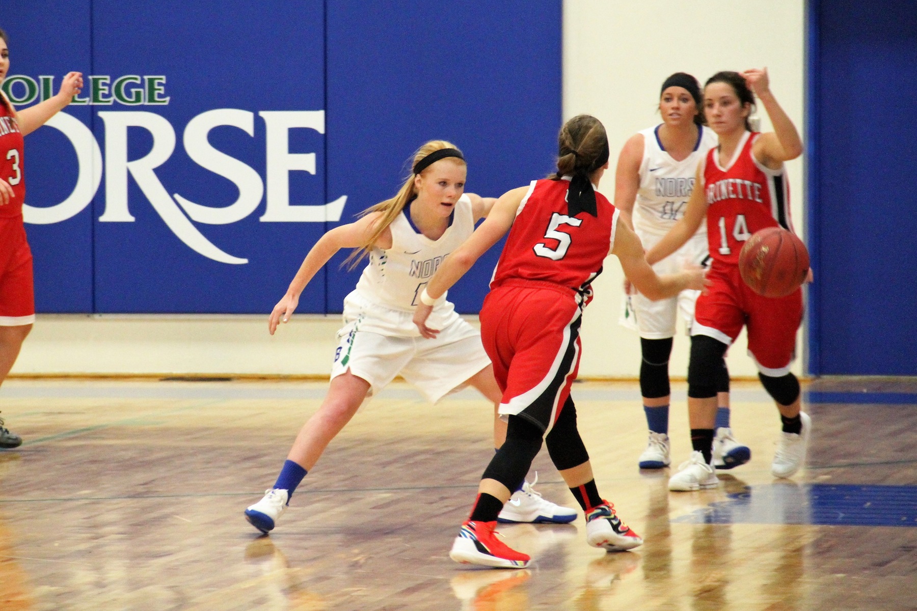 Paige Welch in a defensive stance as her opponent dribbles right