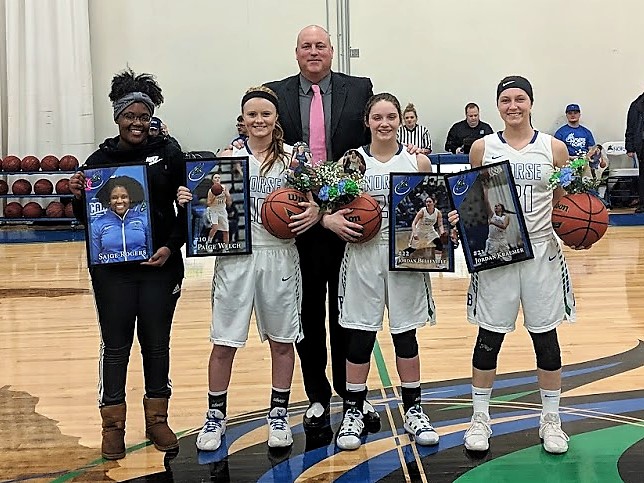 Saige Rogers, Paige Welch, Jordan Belleville, and Jordan Kraemer pose with their sophomore gifts of pictures and flowers along with Rob Robinson