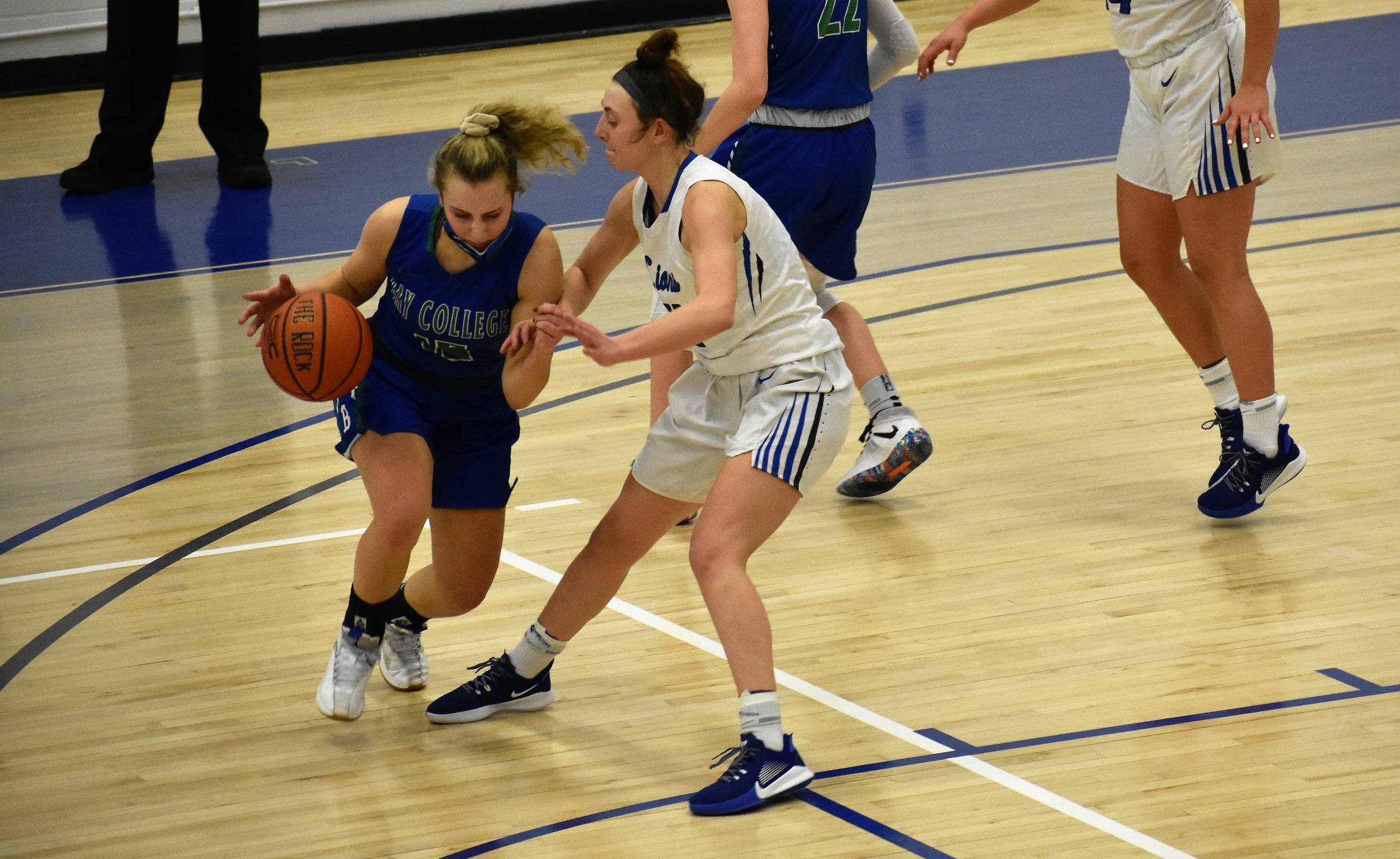 Holly Wardynski tries to dribble to her right with a defender closely guarding her.