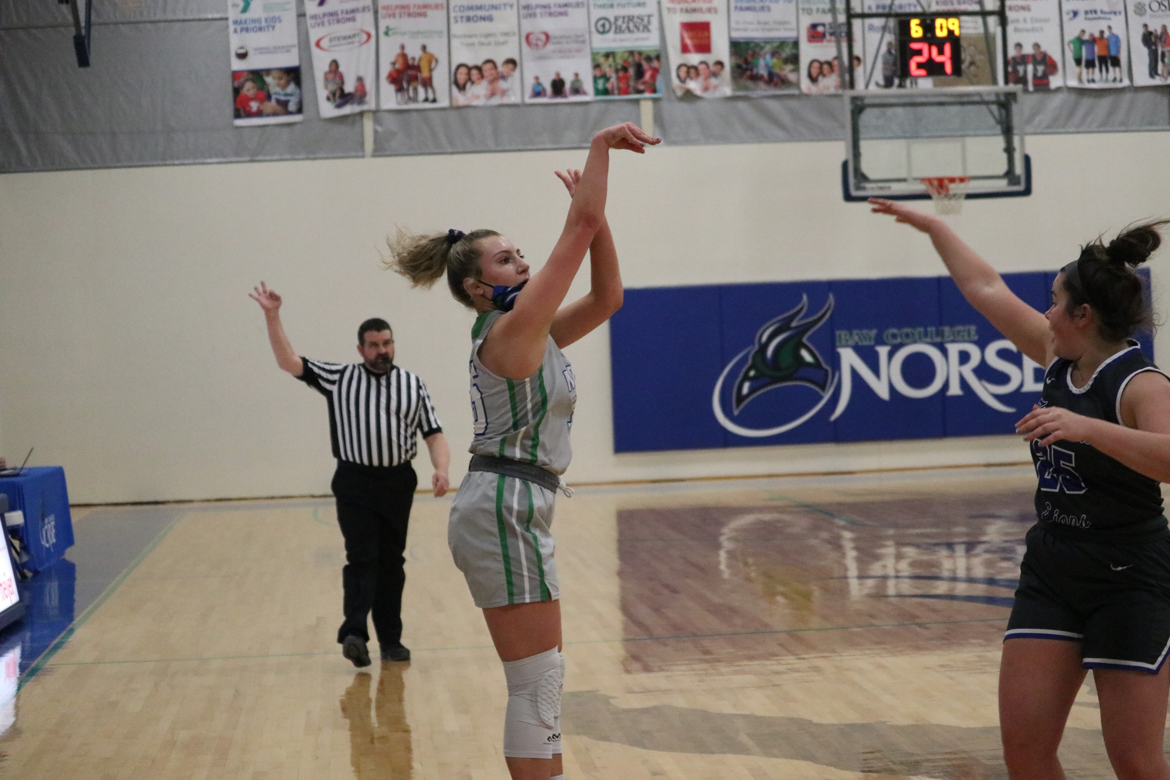 Holly Wardynski holding her follow through after just releasing a three-point attempt