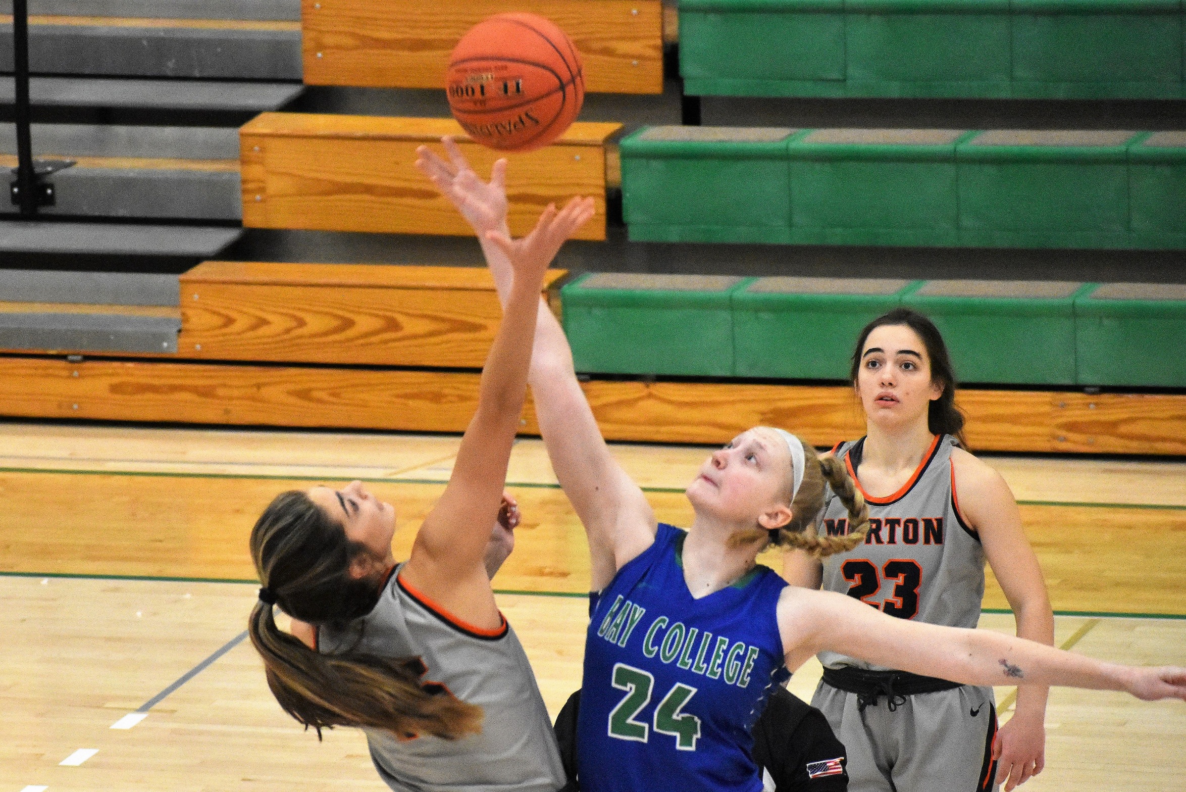 Madison Olsen reaches for the opening tip against a Morton player