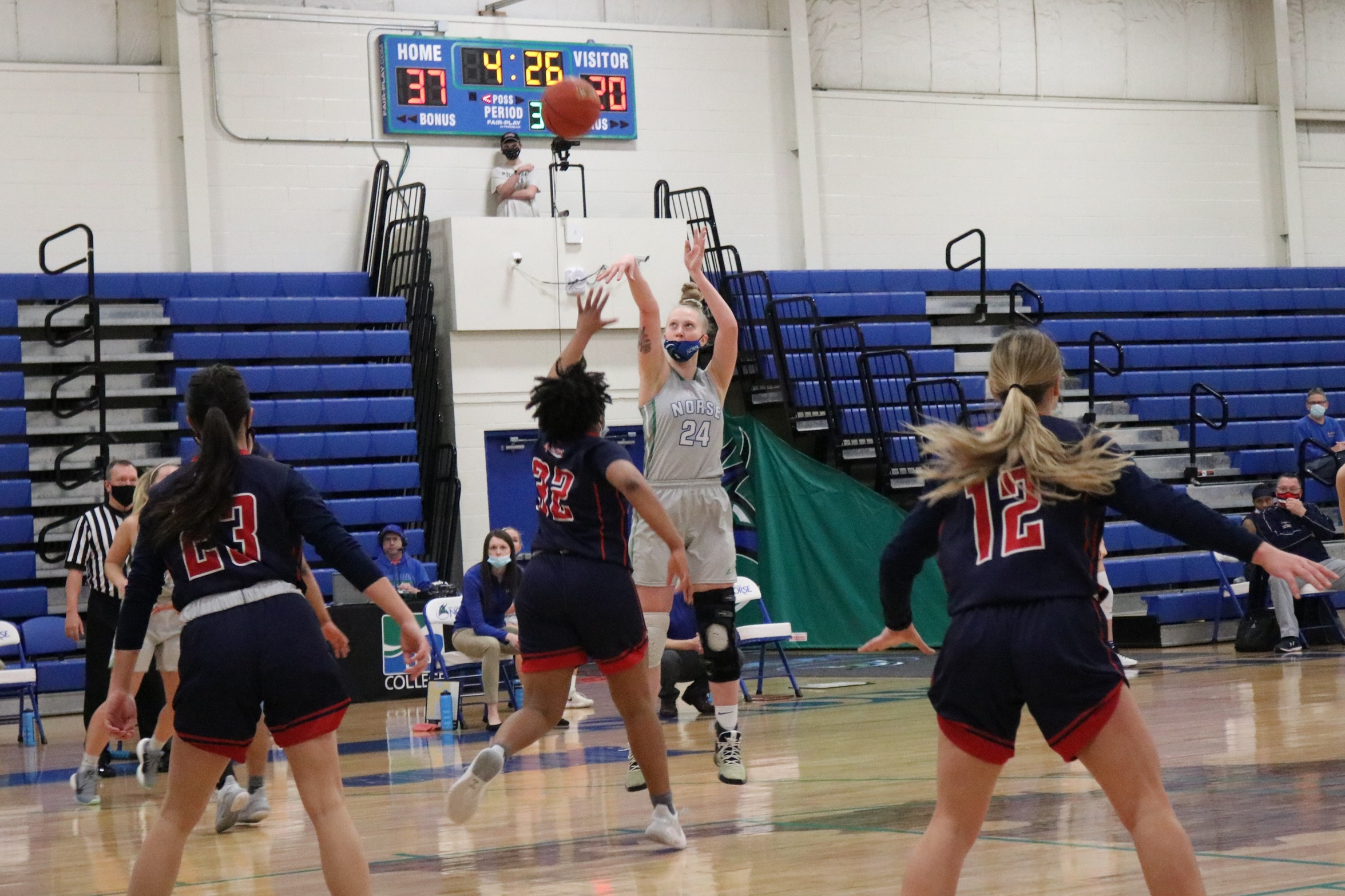 Madison Olsen shoots a three as a defender closes in on her