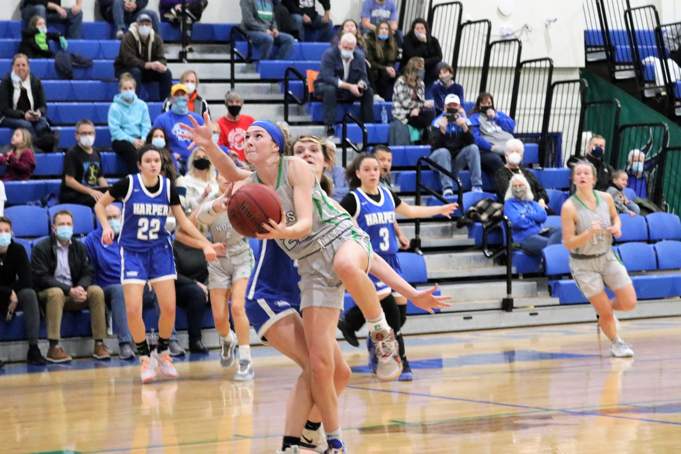 Cheveney Koski fights through contact in the lane as she turns to shoot the ball