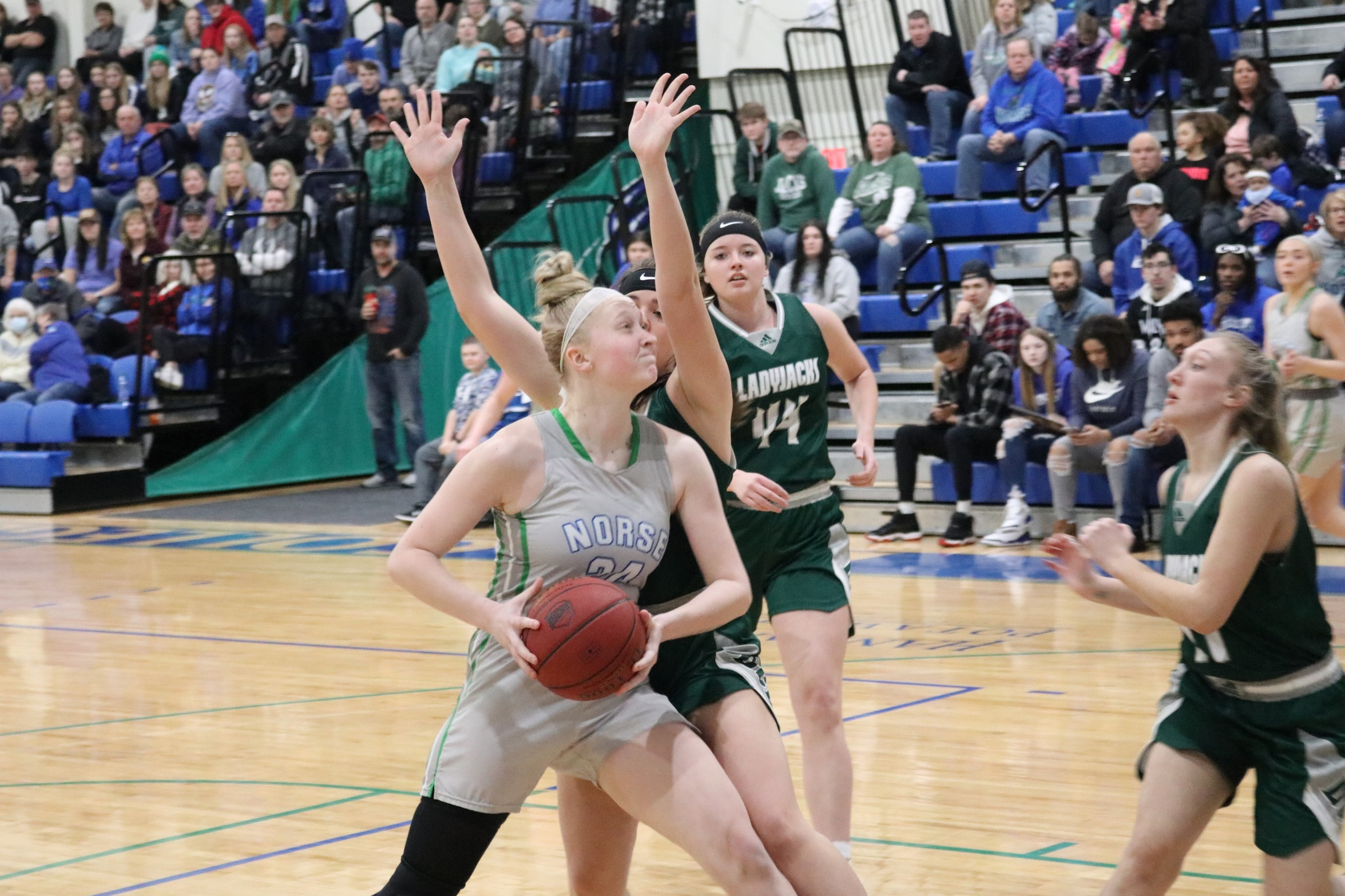 Madison Olsen moves to the rim in the post with a defender closely gaurding