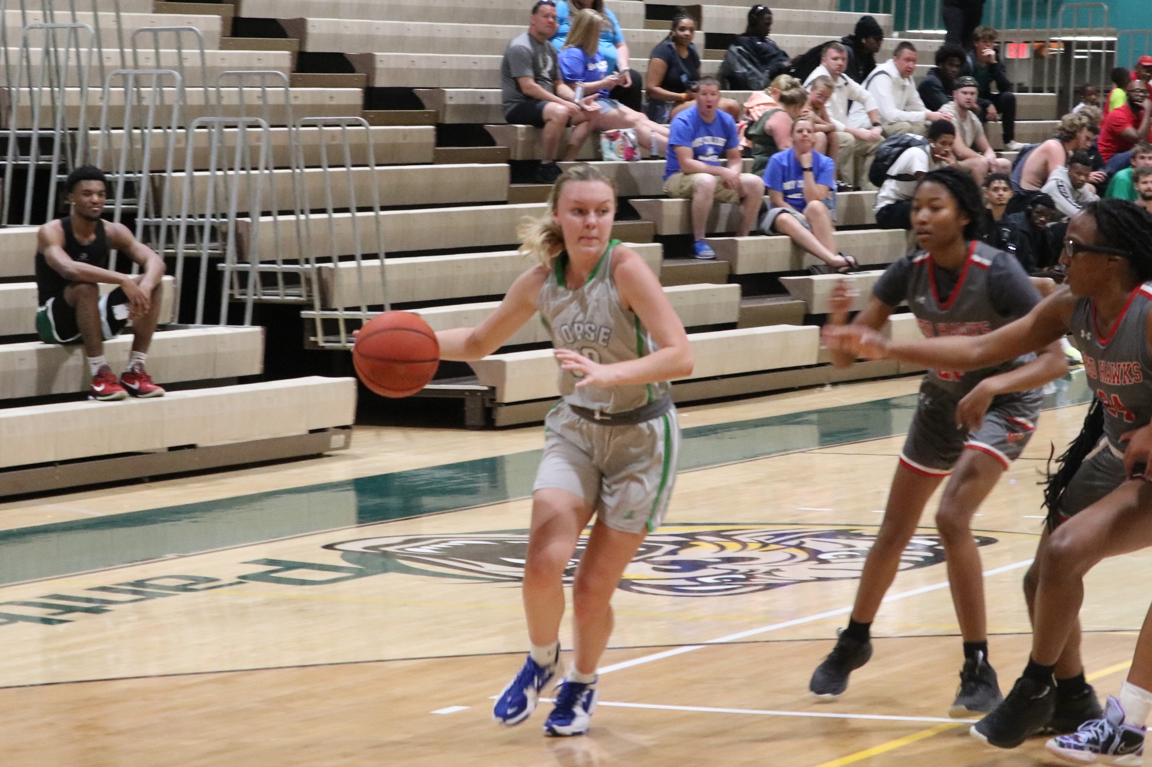 Claire van Ginhoven drives to the basket with defenders looking on