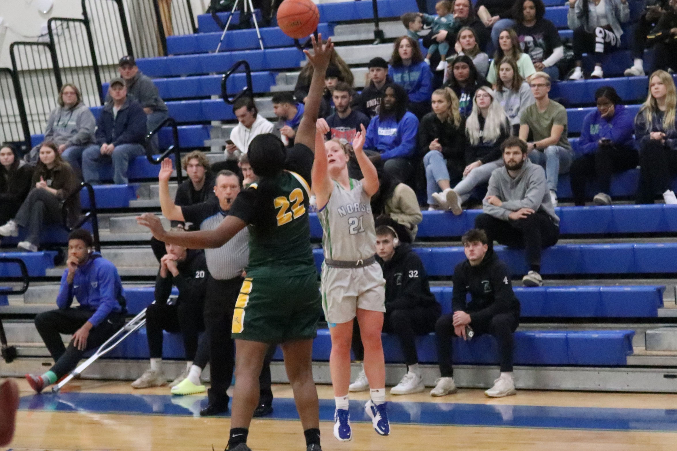 Alaina Trudeau shoots from three as the defender closes in