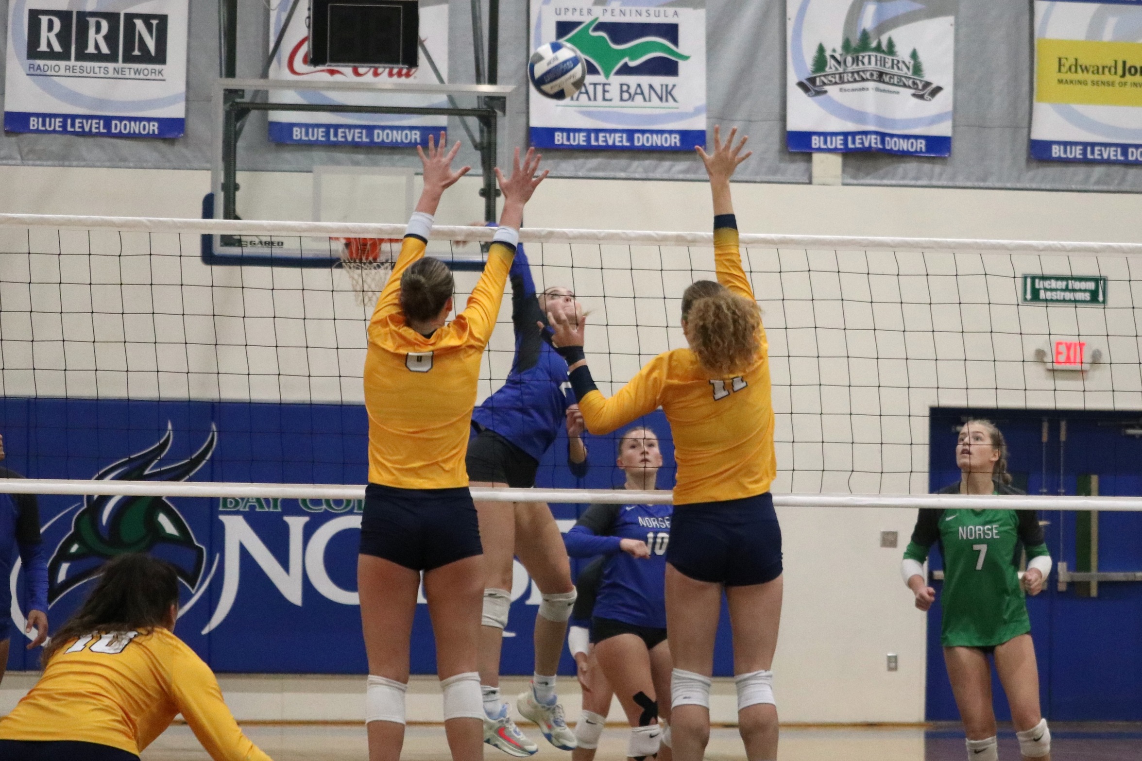 Piper Monroe extends for a kill as two opponents attempt to block