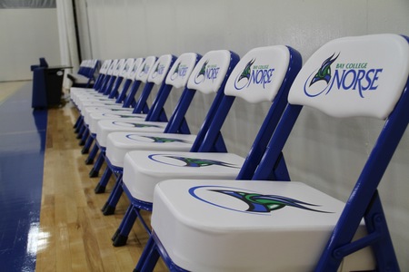 padded Bay Norse chairs lined up on the team bench