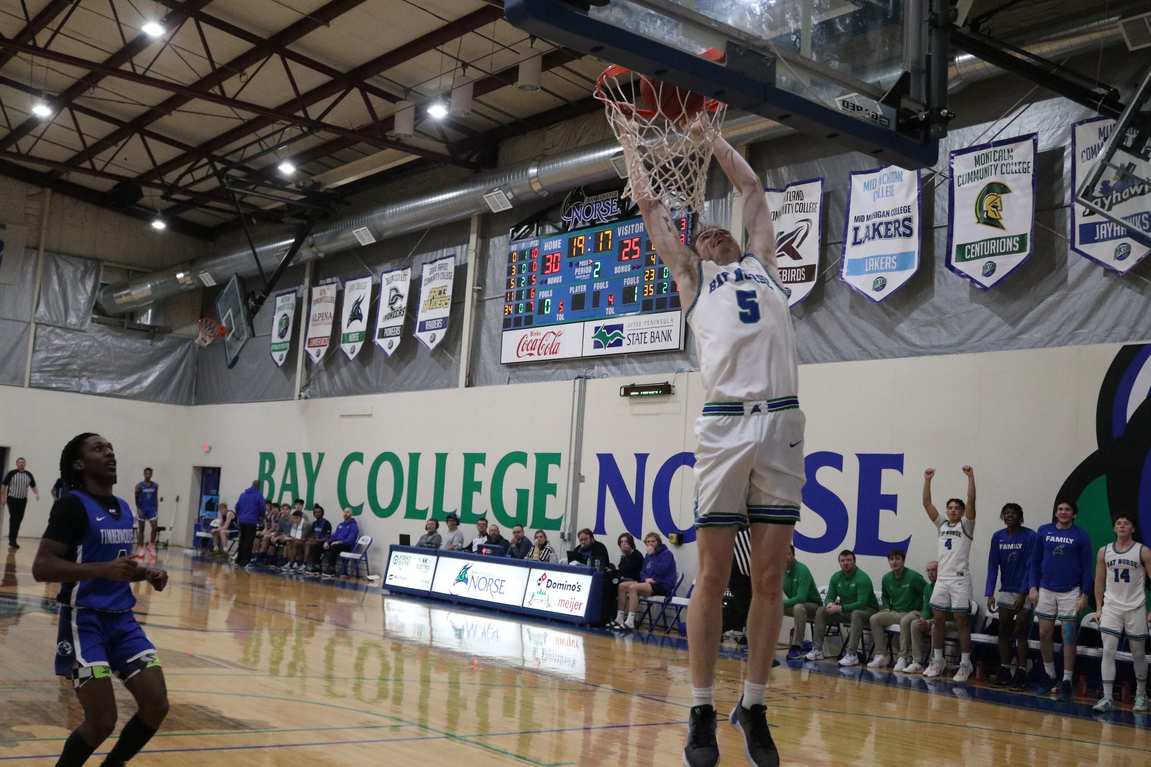 Ryan Sweeney finishing a dunk as a defender looks on