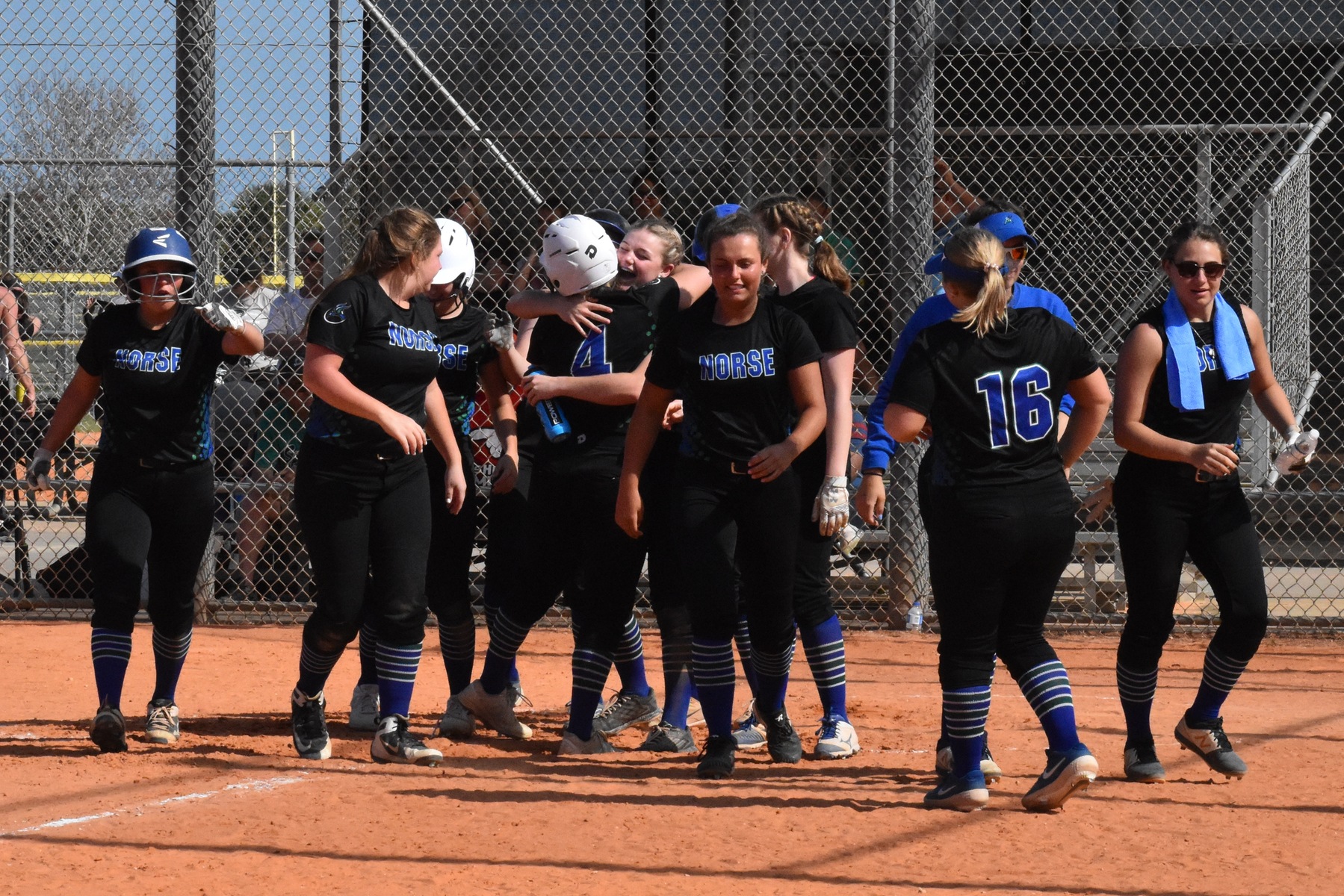 Norse Softball celebrates Lexi Chaillier's home run at the plate.
