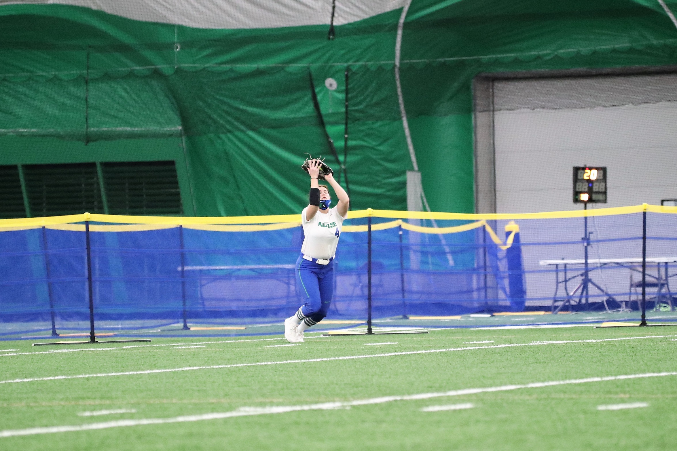 Lexi Challier makes a catch near the outfield fence