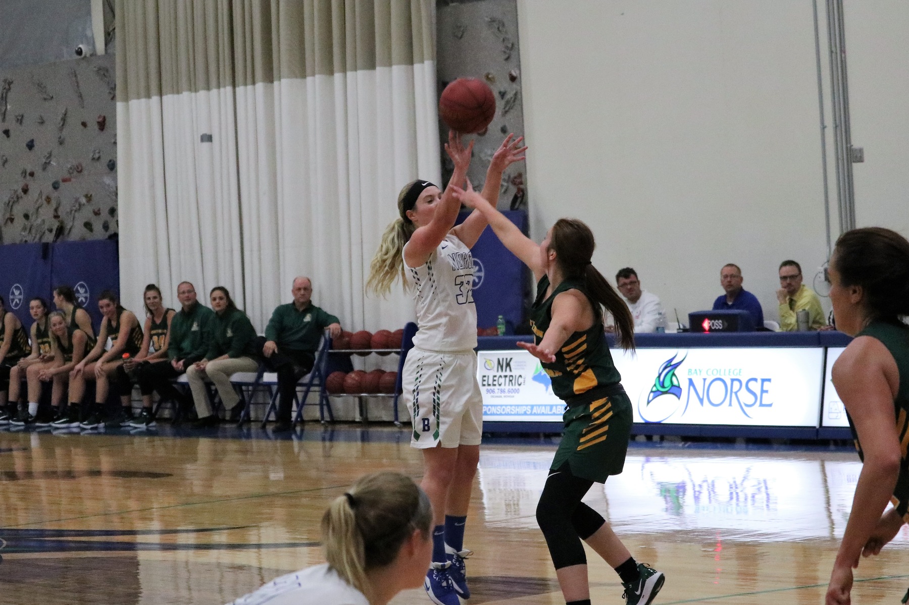 Haley Trudell shots a three over a defender