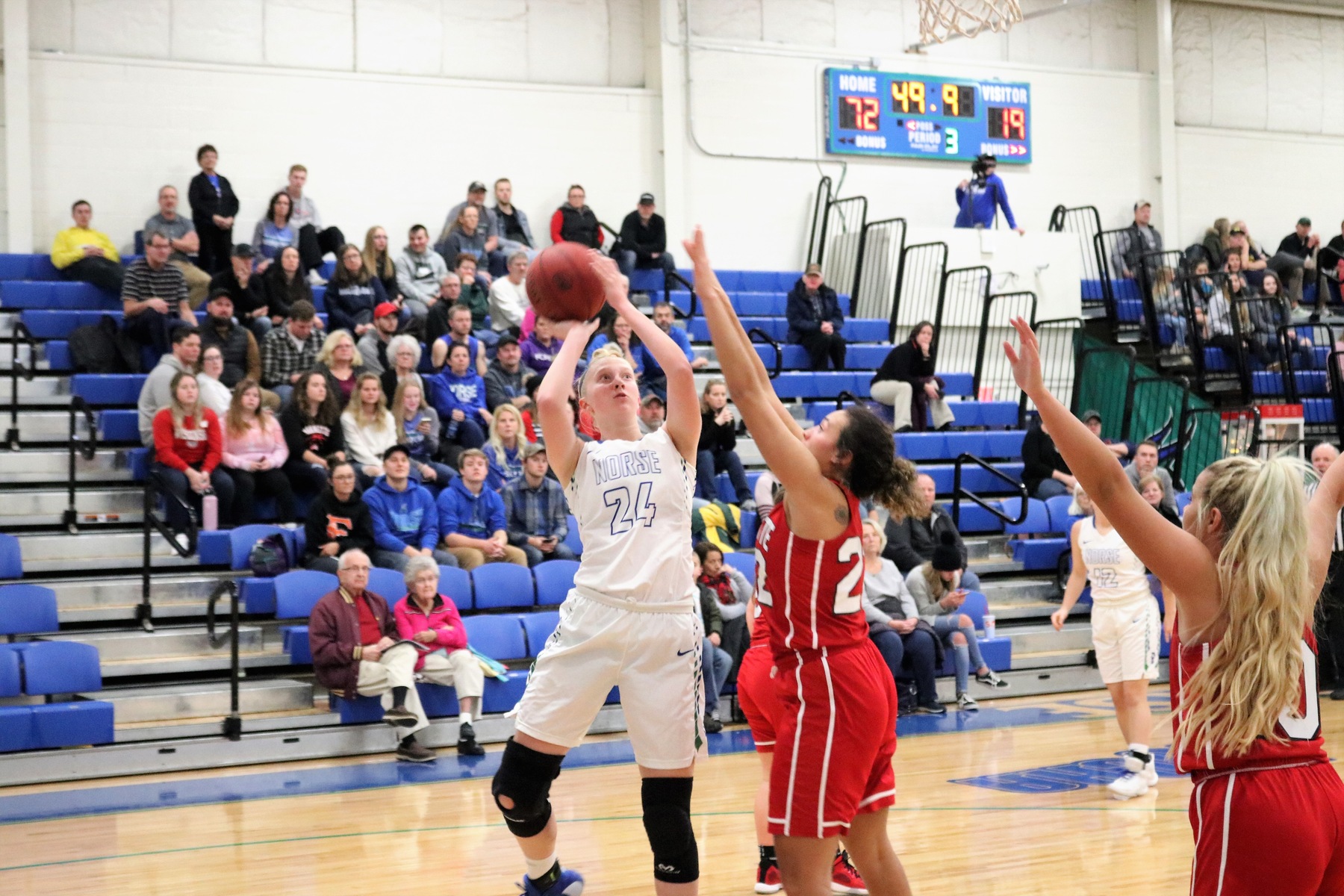 Madison Olsen shoots a jumper with a defender closing in