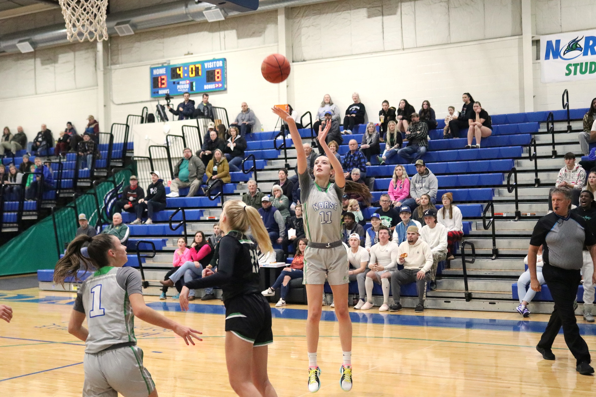 Kennedy Sproule releasing a jump shot as others look on